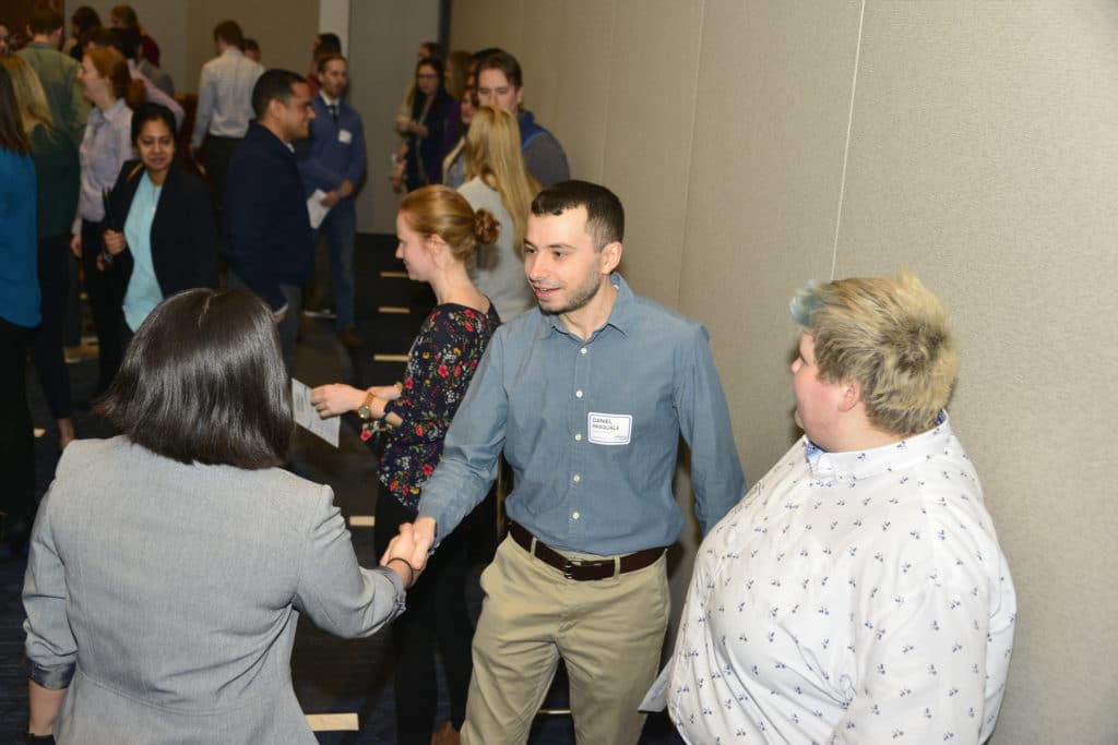 Photo shows three young professionals, including Monika Ingalls, meeting and networking at the NEWEA Summit