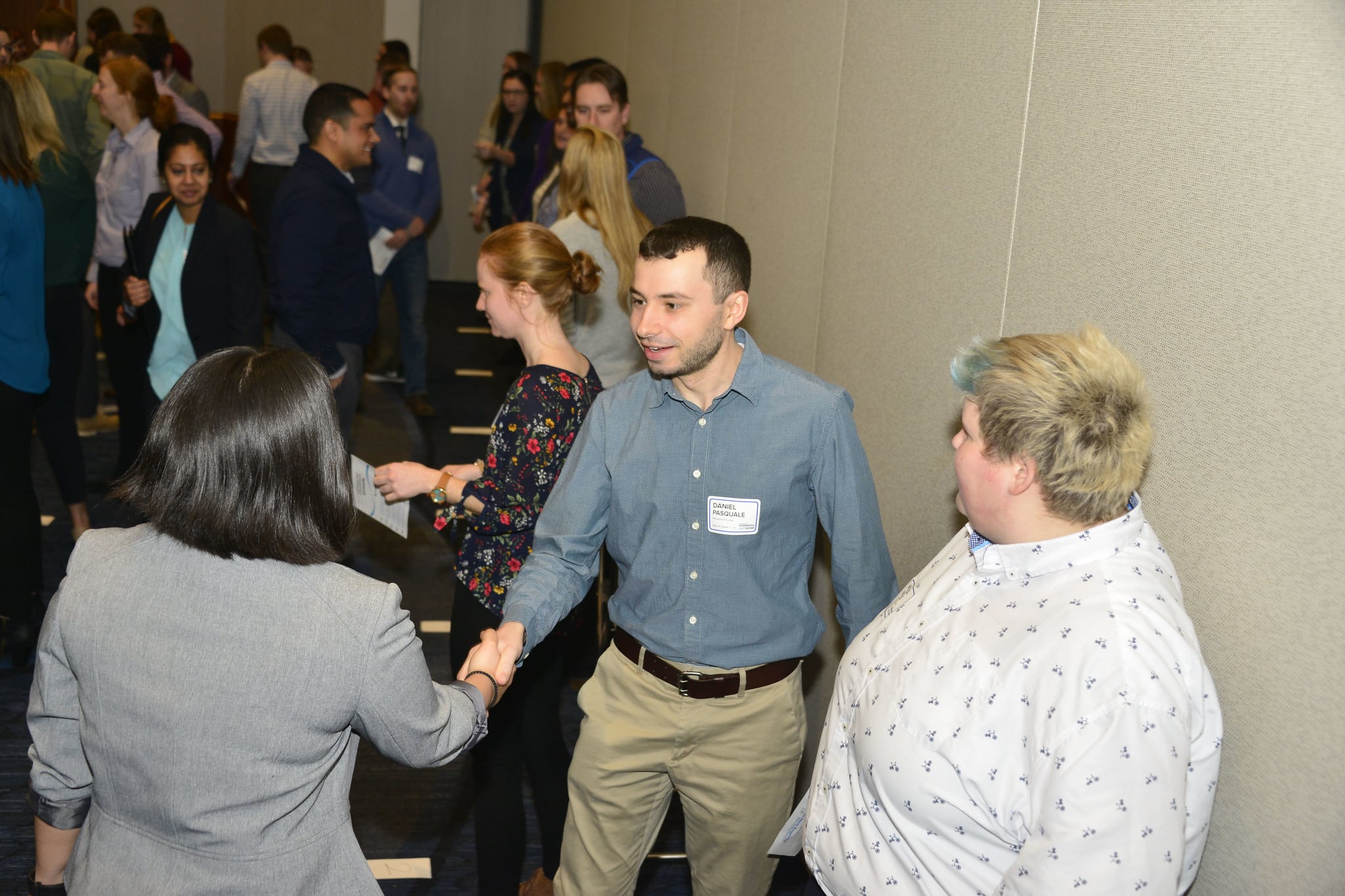 Photo shows three young professionals, including Monika Ingalls, meeting and networking at the NEWEA Summit