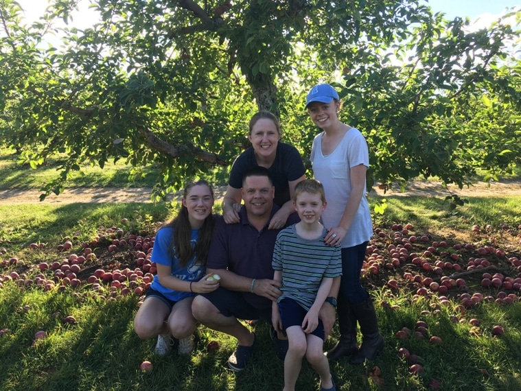 Paul Dustin and Family in apple orchard